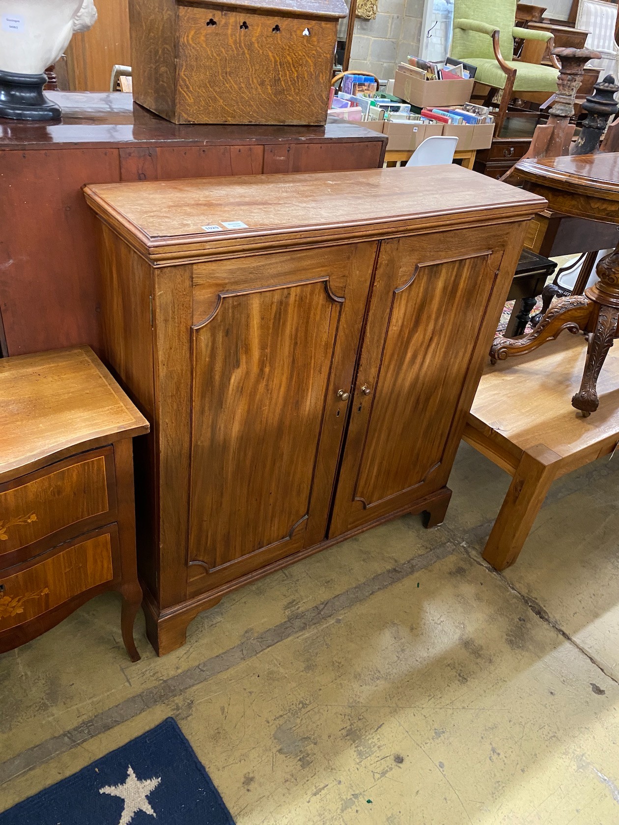 An early 19th century mahogany two door cupboard width 107cm, depth 33cm, height 113cm.